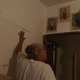 Aileen Rodríguez showing how high the water was when it flooded her home during Hurricane Maria.